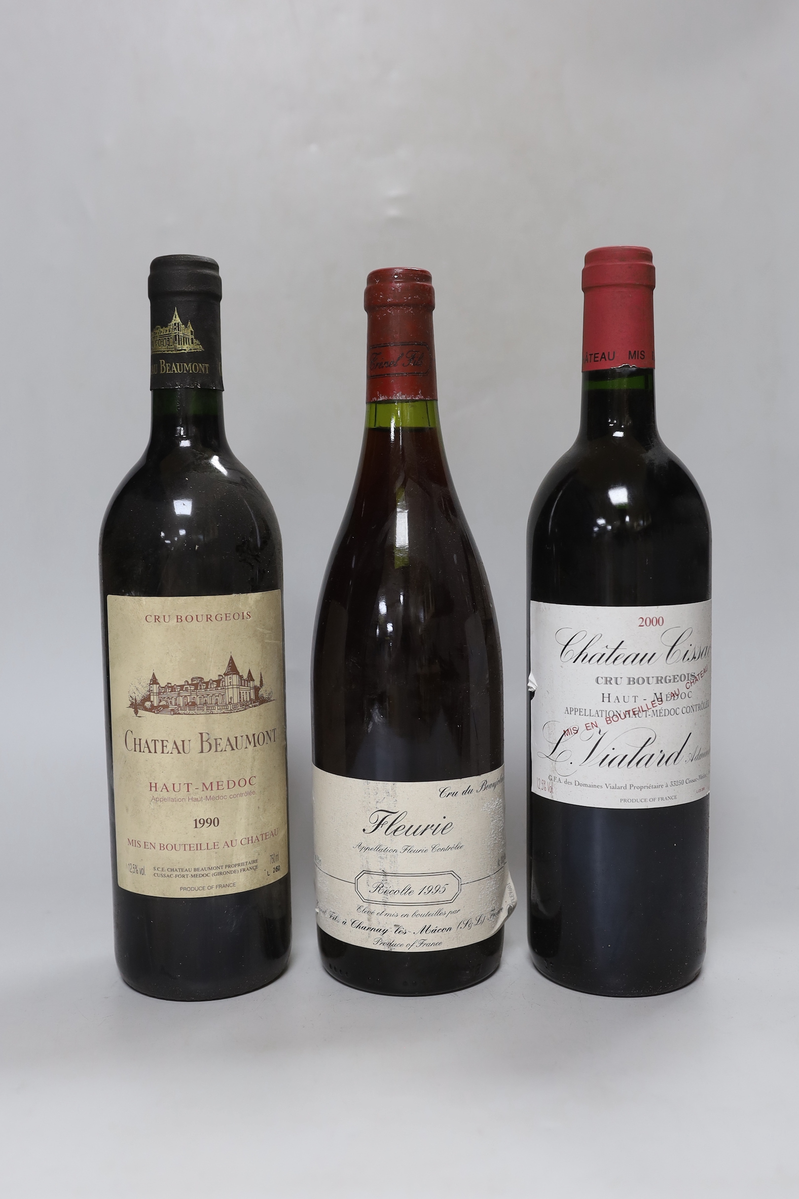 Three bottles of wine: one bottle of 75cl 1990 Chateau Beaumont Haut-Medoc, one bottle of 75cl 1995 Fleurie Cru du Beaujolais, and one bottle of 75cl 2000 Château Cissac Haut-Medoc